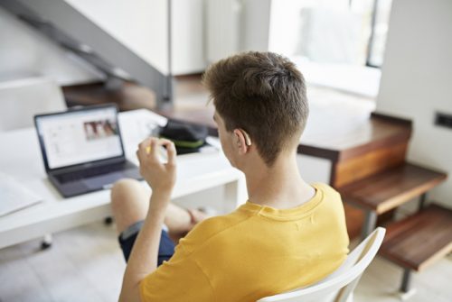Student using sign language with virtual sign language interpreter on computer