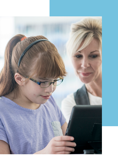 Teacher supporting a visually impaired student using a tablet for guided learning.